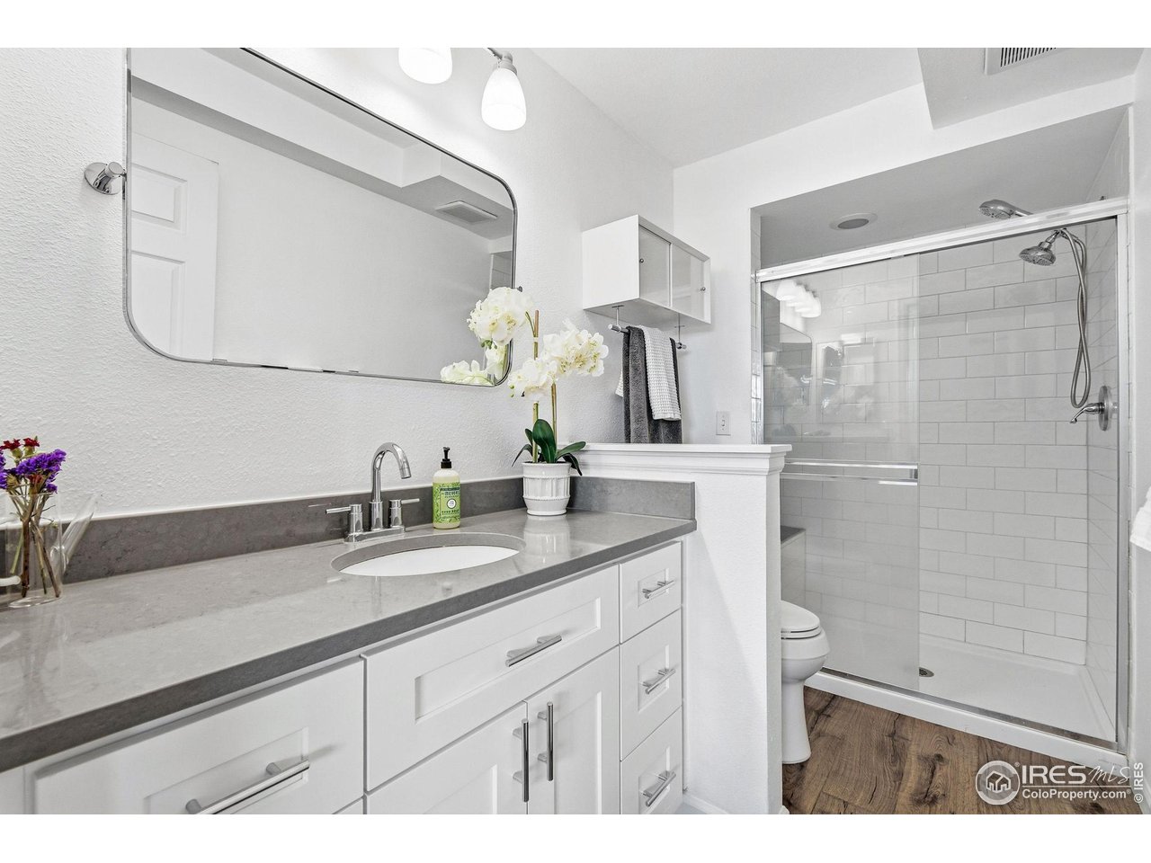 3077 29th Street, Unit 105 Boulder, CO 80301 - Photo 18 of 27 a bathroom with a sink and a mirror