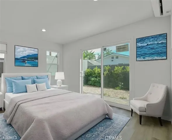 a bedroom with a bed and a painting on the wall