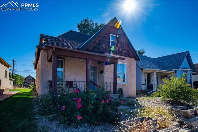 a view of a house with backyard and sitting area