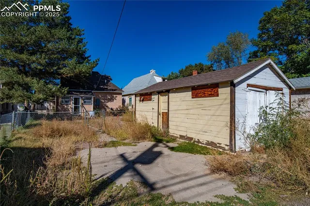 an aerial view of a house with a yard and fountain