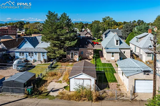 an aerial view of residential houses with outdoor space