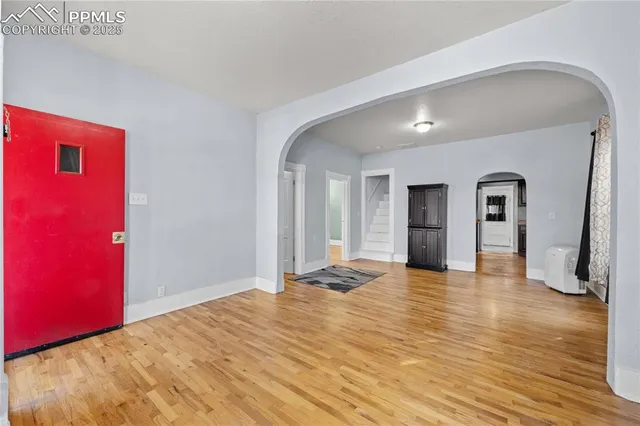 a view of empty room with wooden floor