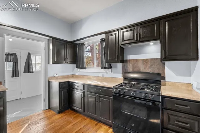 a kitchen with stainless steel appliances granite countertop a stove and a sink