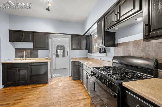 a kitchen with stainless steel appliances granite countertop a stove and a sink