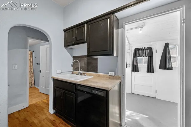 a kitchen with a refrigerator a stove cabinets and wooden floor