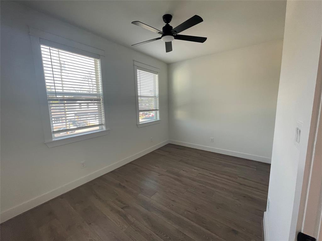 3535 Spring Avenue Dallas, TX 75210 - Photo 6 of 19 Empty room featuring a ceiling fan and dark wood-style floors
