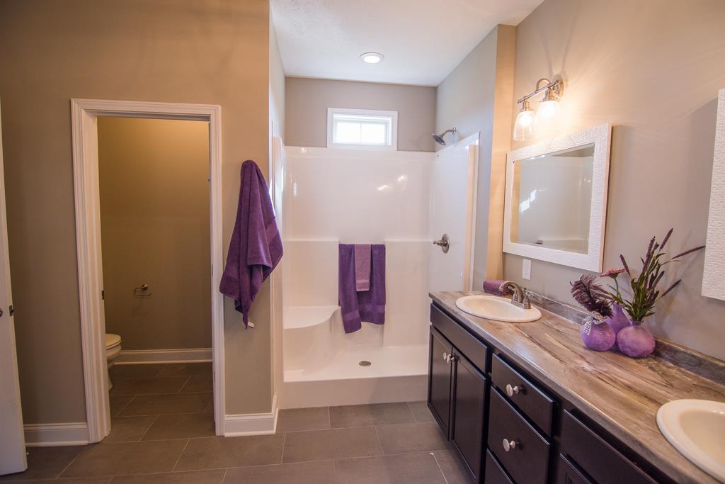 1 Beech Grove Clarksville, TN 37043 - Photo 7 of 30 a bathroom with a double vanity sink a mirror and shower