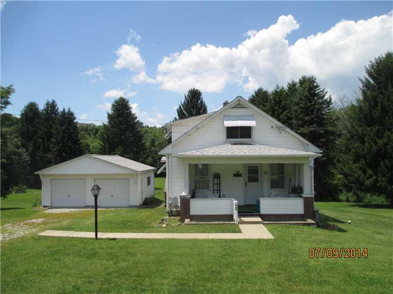 Exterior Front. Situated in Kiski Twp. on 2.03  acres this charming home will soon calm your senses amidst the natural surroundings. The nostalgic front porch boasts louvered side windows for enjoying the seasons. A two car 27x23 garage is within access to the home.