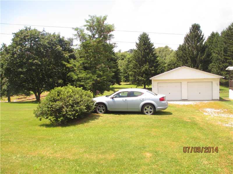 416 Kings Road Apollo, PA 15613 - Photo 3 of 20 Exterior Front. Large driveway with area for turning. Garage is cemented and boasts insulated doors. One side has an opener.Size of garage is 27 feet x23 feet .
