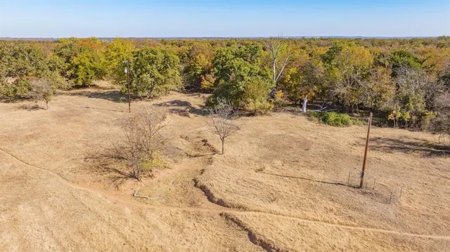 a view of a livingroom with furniture and a window