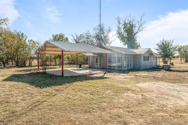 a kitchen with stainless steel appliances granite countertop a stove top oven a refrigerator a sink and dishwasher with wooden cabinets