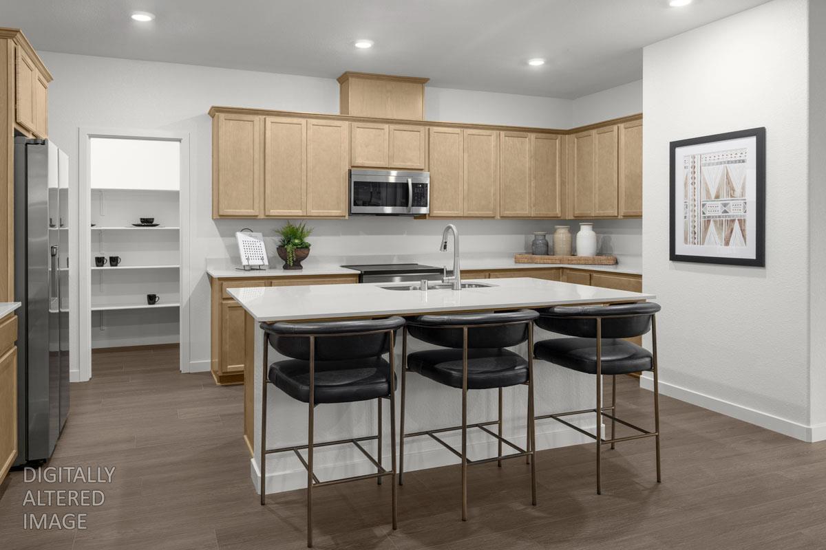 2328 Lingcod Way Rocklin, CA 95765 - Photo 2 of 6 a kitchen with stainless steel appliances kitchen island granite countertop a table chairs microwave and sink