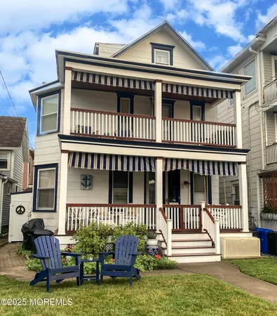a view of a house with a deck and furniture