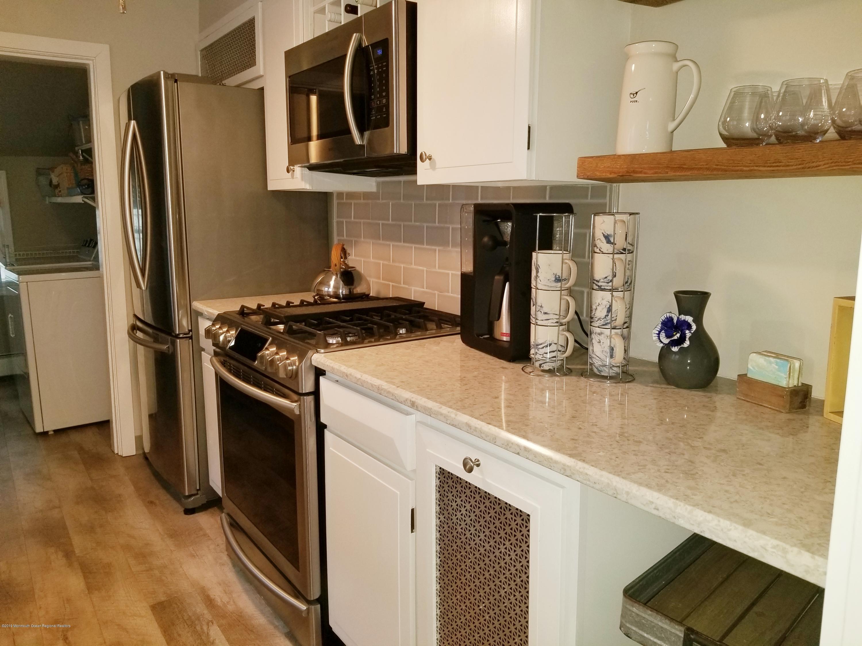12 Surf Avenue Ocean Grove, NJ 07756 - Photo 12 of 26 a kitchen with stainless steel appliances granite countertop a stove and a refrigerator
