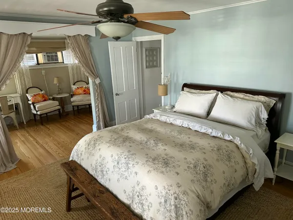 a spacious bedroom with a bed and a chandelier
