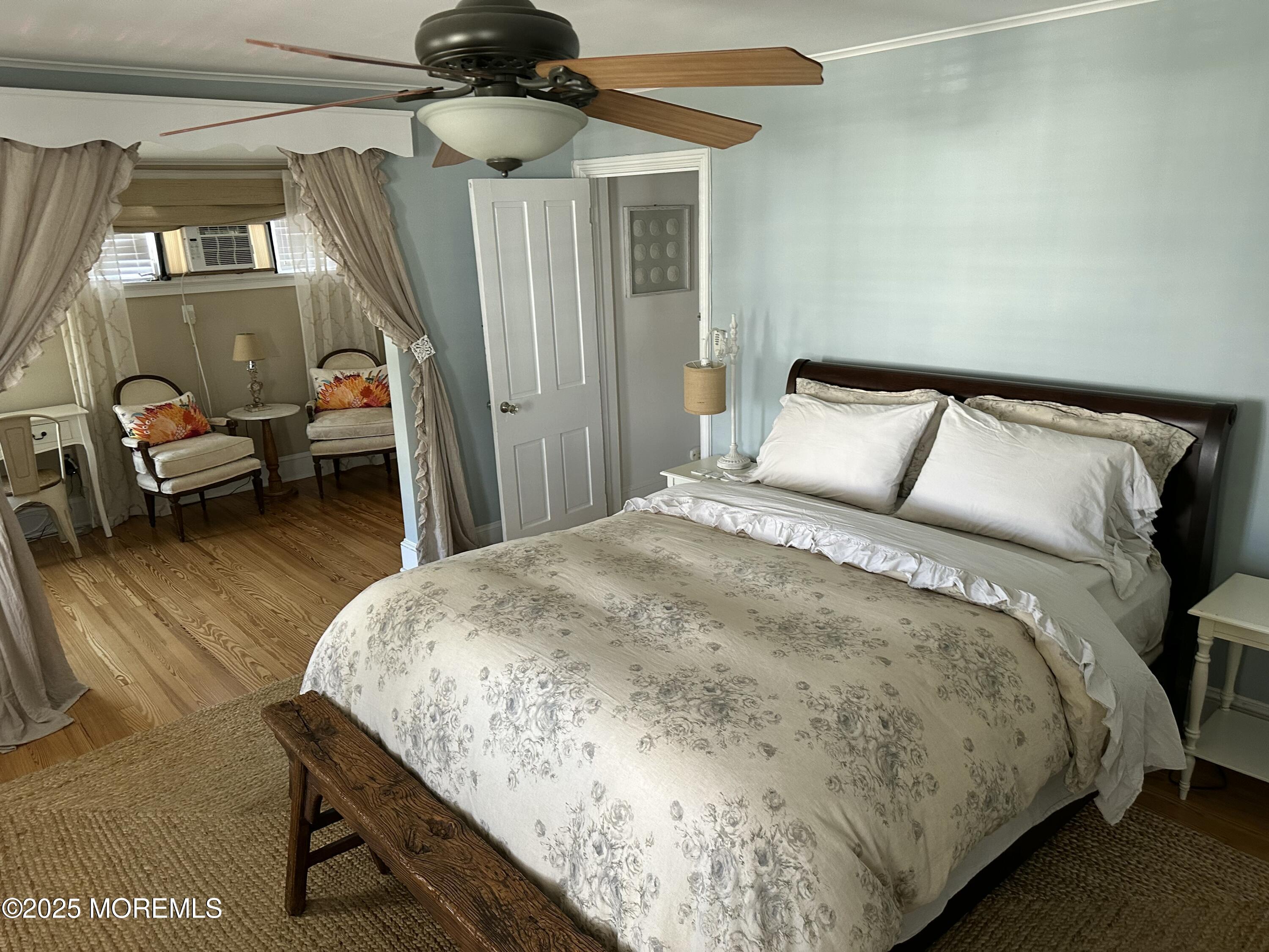 12 Surf Avenue Ocean Grove, NJ 07756 - Photo 16 of 26 a spacious bedroom with a bed and a chandelier