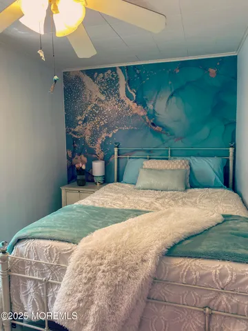 a bedroom with a bed and a chandelier