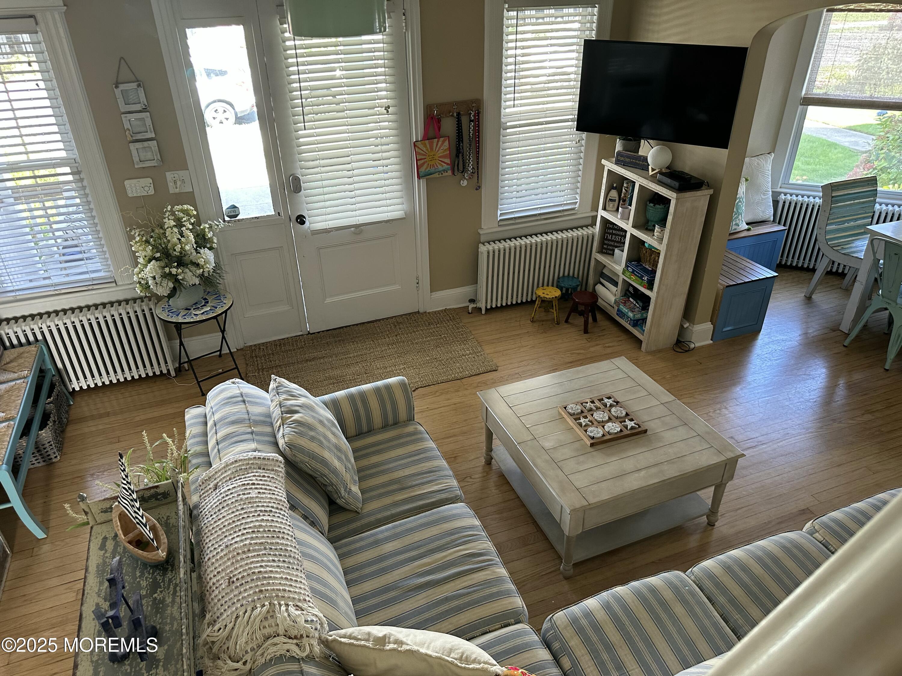 12 Surf Avenue Ocean Grove, NJ 07756 - Photo 5 of 26 a living room with furniture and a flat screen tv