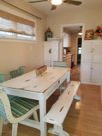 a large white kitchen with a table and chairs