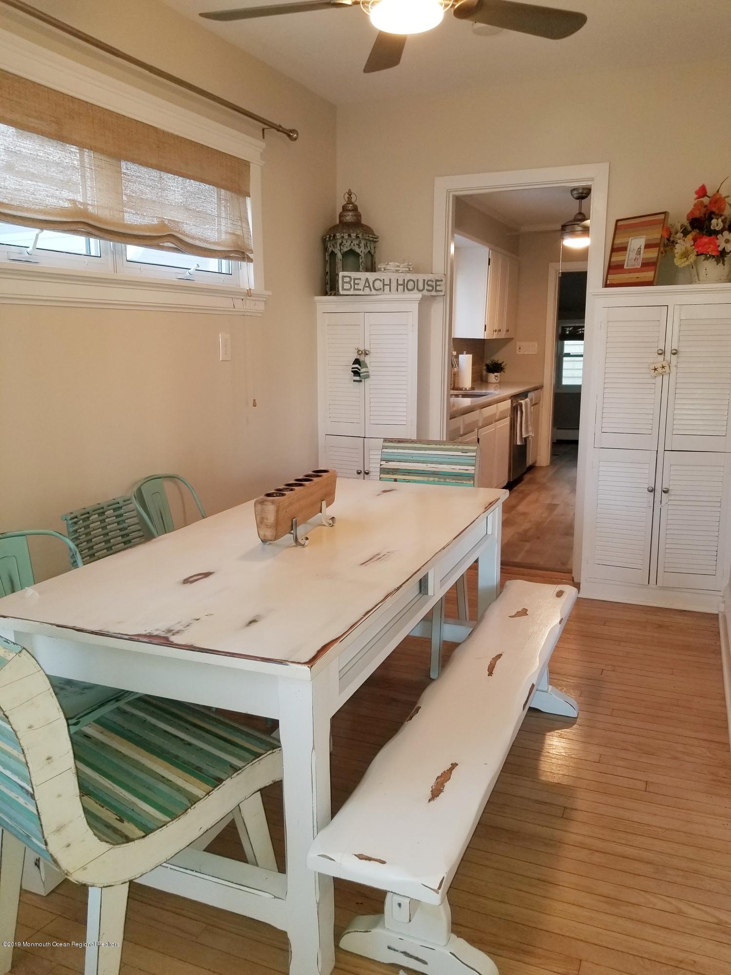 12 Surf Avenue Ocean Grove, NJ 07756 - Photo 9 of 26 a large white kitchen with a table and chairs