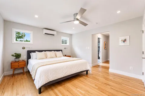 a bedroom with a bed and wooden floor