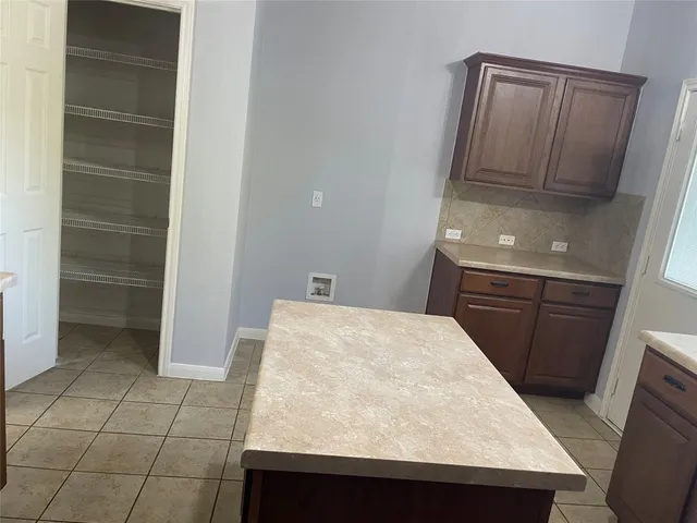 an empty room with wooden floor and mirror