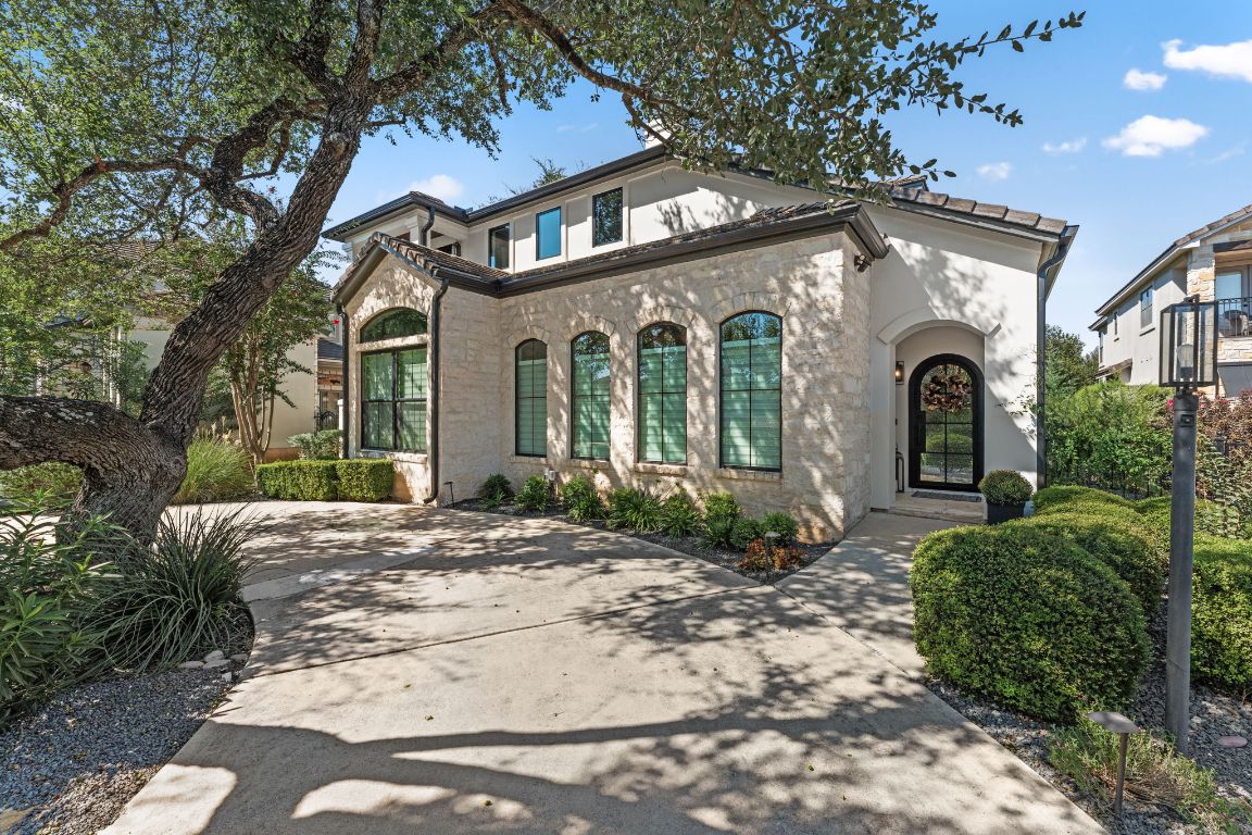 a front view of a house with garden