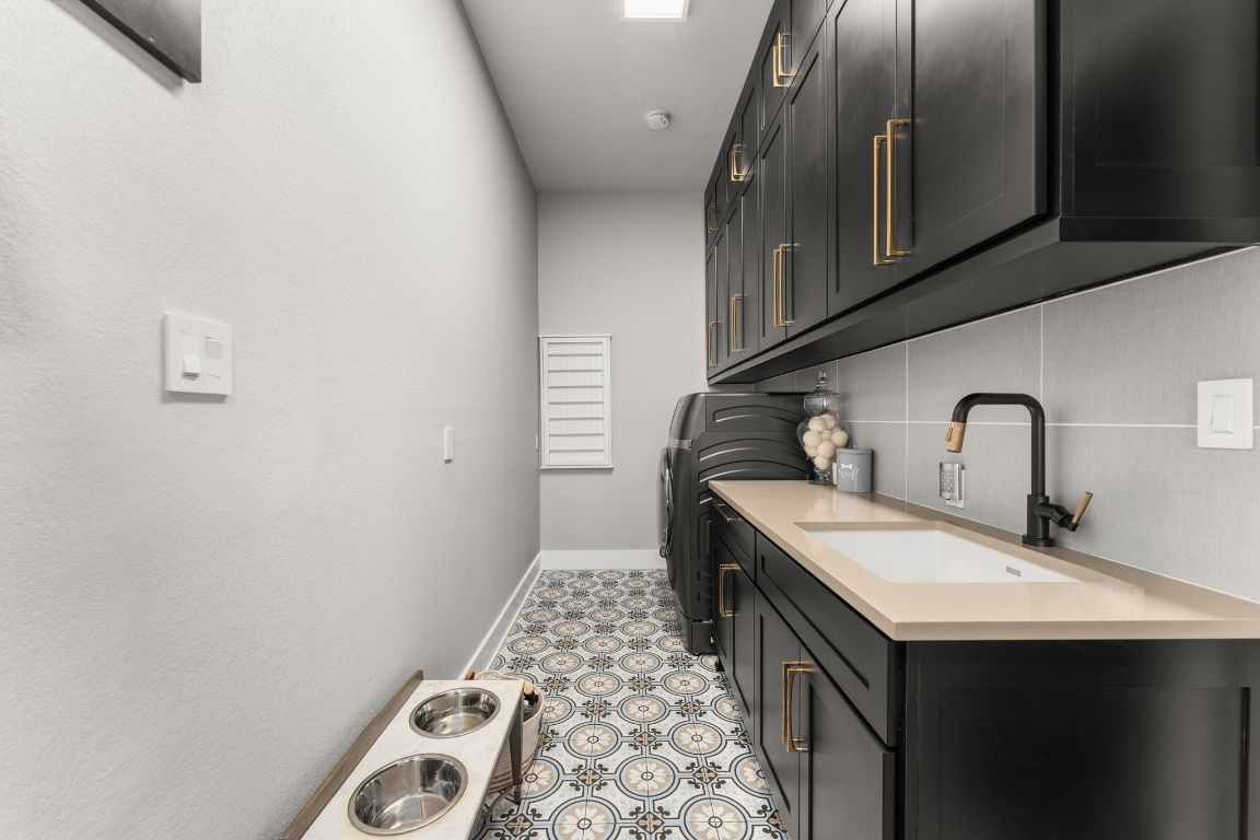 8 Hightrail Way The Hills, TX 78738 - Photo 12 of 15 a kitchen with a sink and cabinets