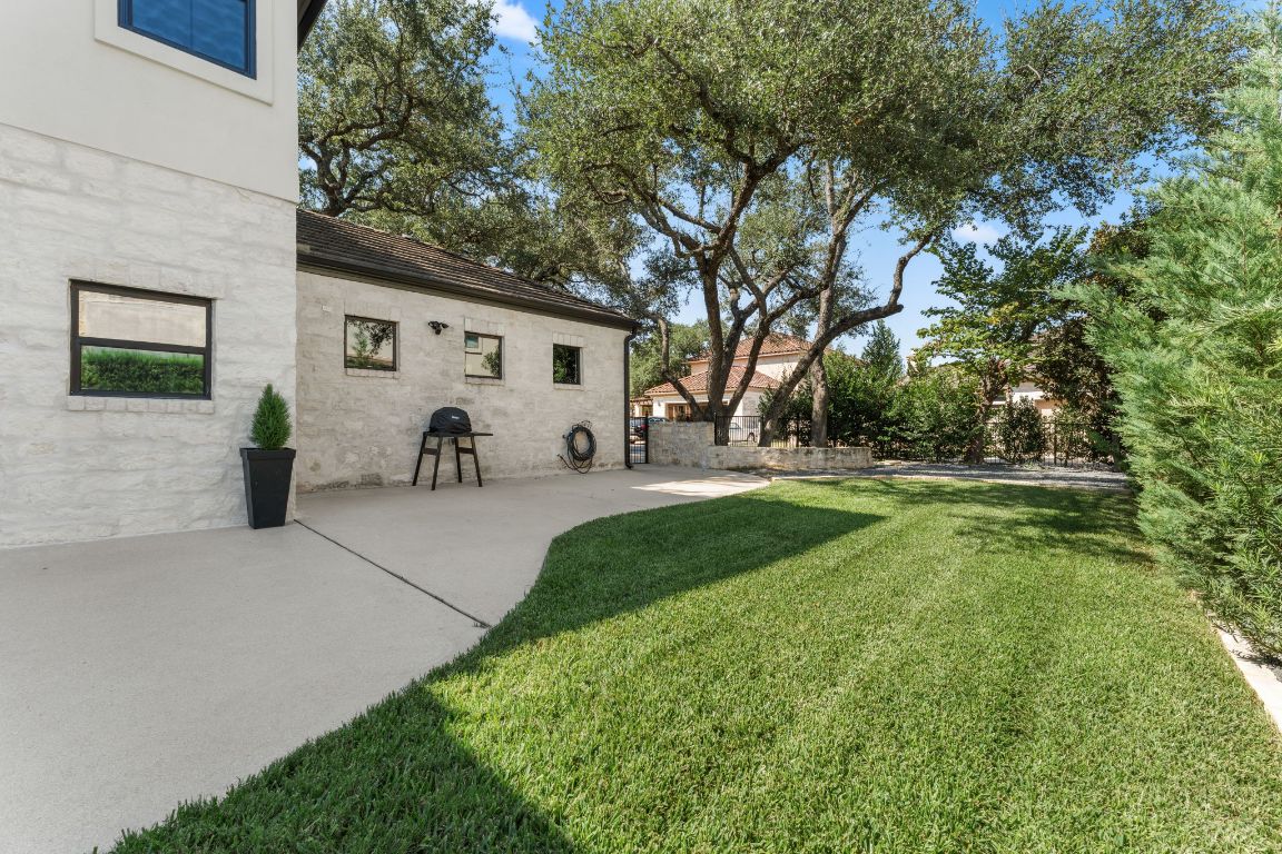 8 Hightrail Way The Hills, TX 78738 - Photo 14 of 15 a view of a white house with a yard and sitting area