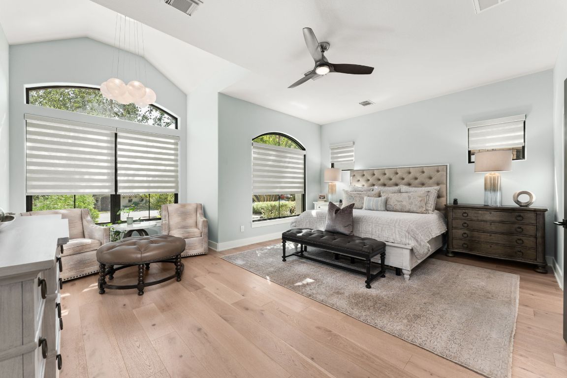 8 Hightrail Way The Hills, TX 78738 - Photo 6 of 15 a spacious bedroom with a bed a couch and a window