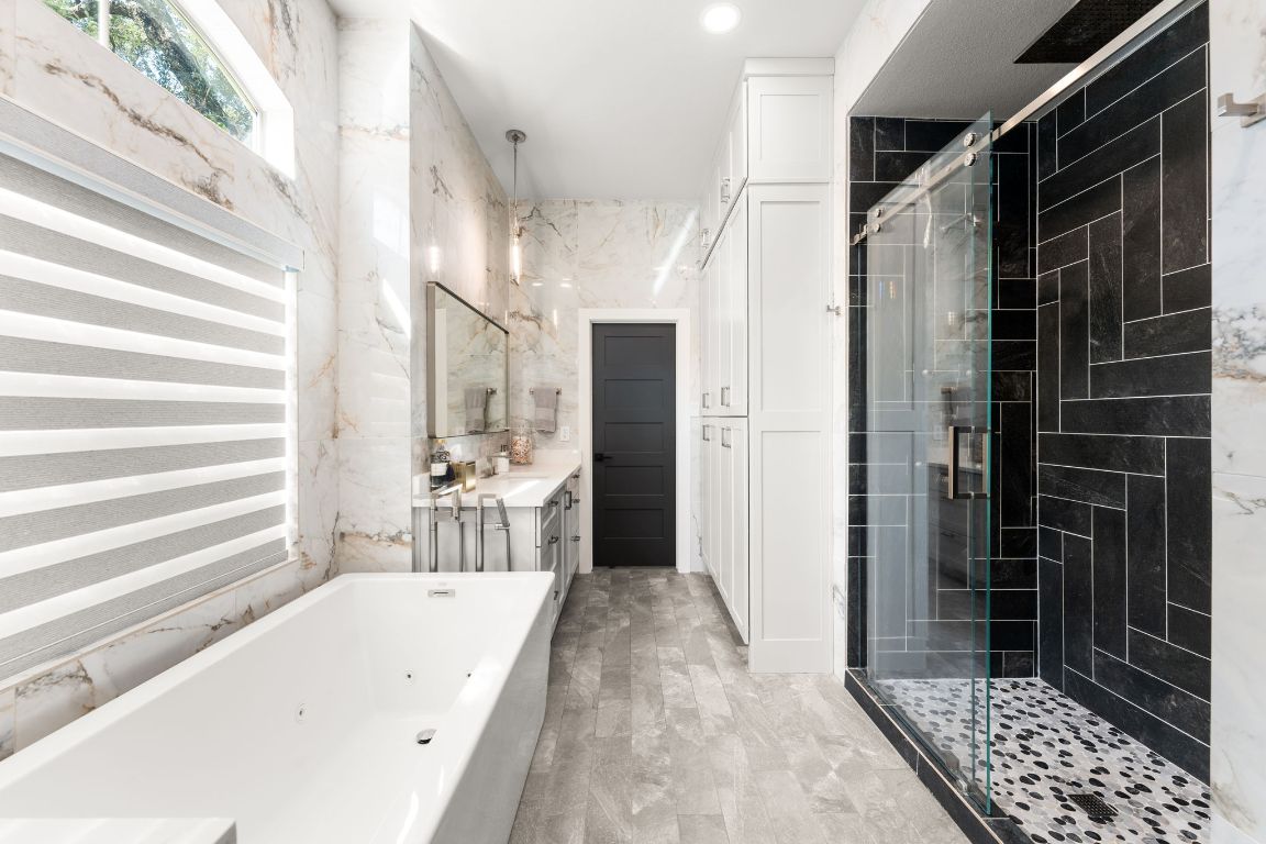 8 Hightrail Way The Hills, TX 78738 - Photo 7 of 15 a bathroom with a bathtub and a shower