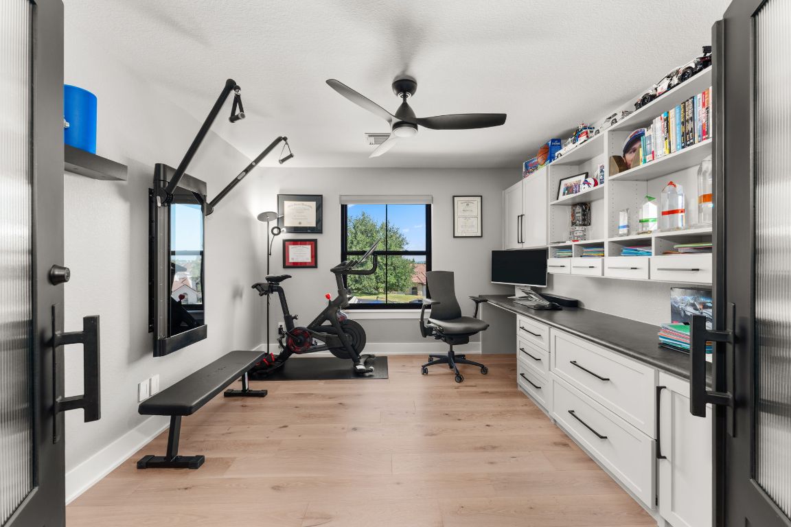 8 Hightrail Way The Hills, TX 78738 - Photo 10 of 15 a view of a livingroom with workspace and windows