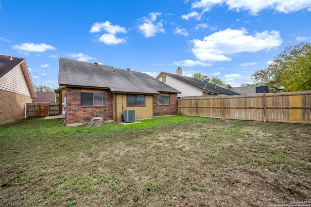 a view of a house with a backyard