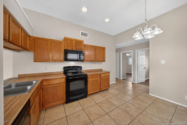 a kitchen with stainless steel appliances granite countertop a sink and a stove