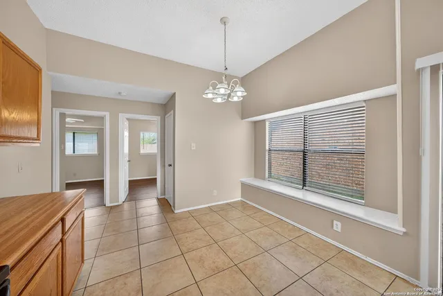 a view of a room with wooden floor and chandelier
