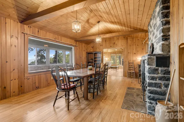 a dining room with furniture window and wooden floor