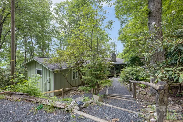 a view of a wooden house with a yard