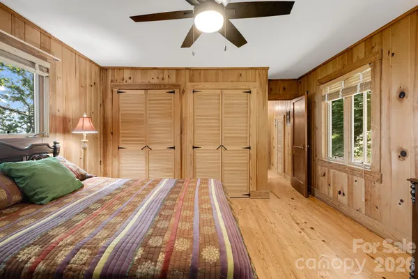 a spacious bedroom with a large bed and a chandelier