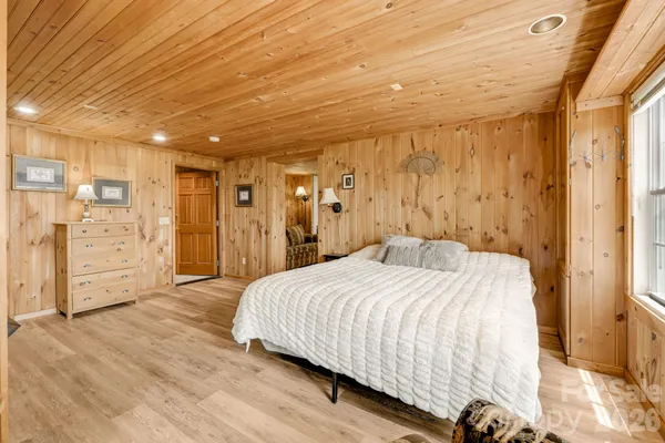 a spacious bedroom with a bed and a walk in closet