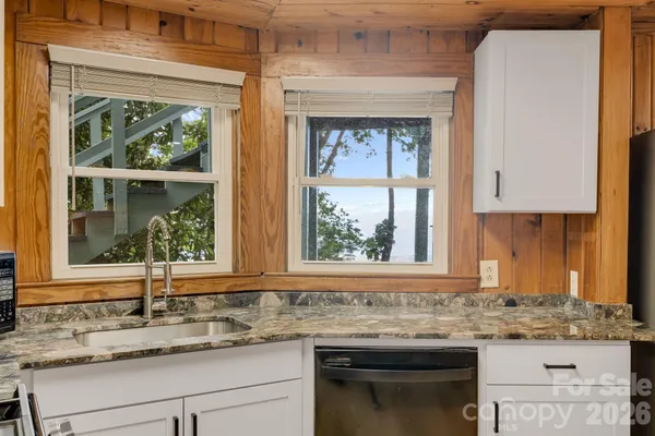 a kitchen with granite countertop a sink and a window