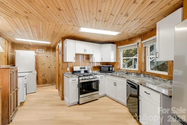 a kitchen with a stove a sink and a refrigerator