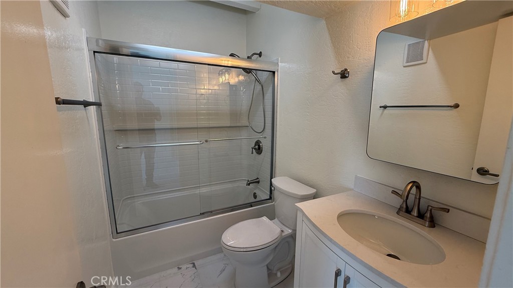 33852 Copper Lantern Street, Unit F Dana Point, CA 92629 - Photo 11 of 44 a bathroom with a granite countertop sink toilet and shower
