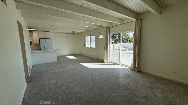 an empty room with a fireplace and windows