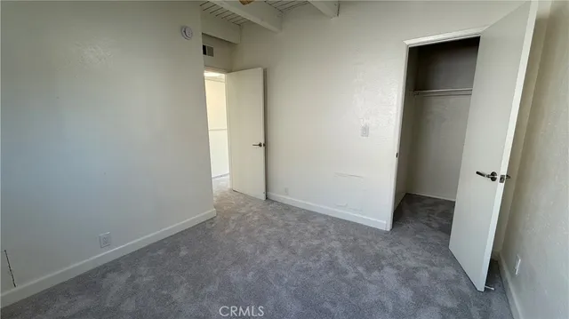 an empty room that has a grey walls