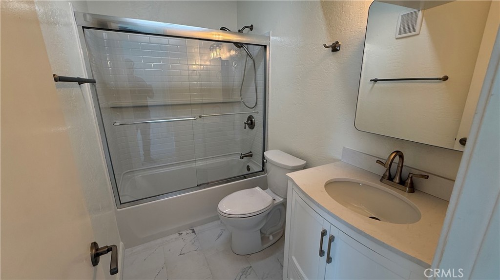 33852 Copper Lantern Street, Unit F Dana Point, CA 92629 - Photo 15 of 44 a bathroom with a granite countertop sink toilet and shower