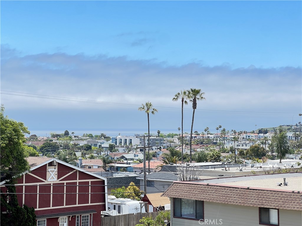 33852 Copper Lantern Street, Unit F Dana Point, CA 92629 - Photo 18 of 44 a front view of a building with streets and trees