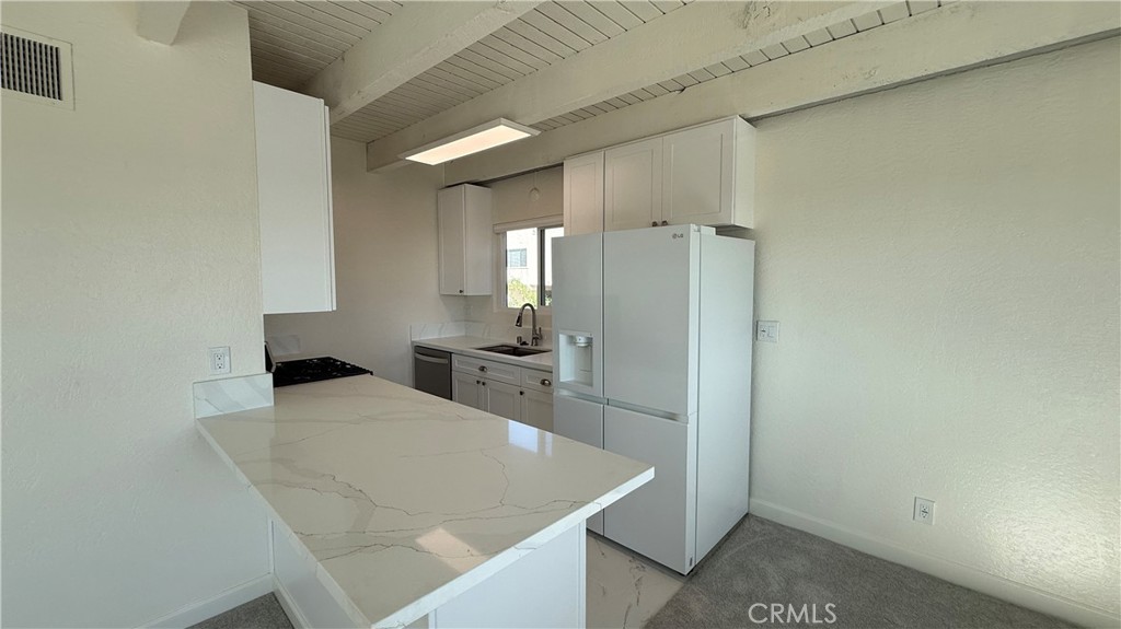 33852 Copper Lantern Street, Unit F Dana Point, CA 92629 - Photo 2 of 44 a kitchen with stainless steel appliances a refrigerator and a stove