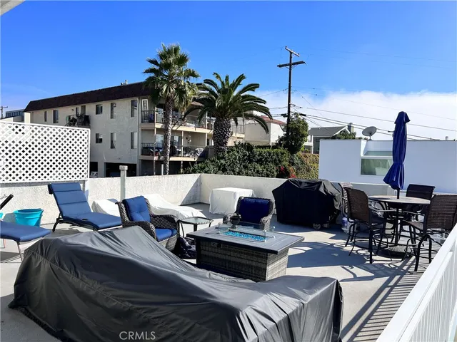 a view of balcony with furniture and potted plants