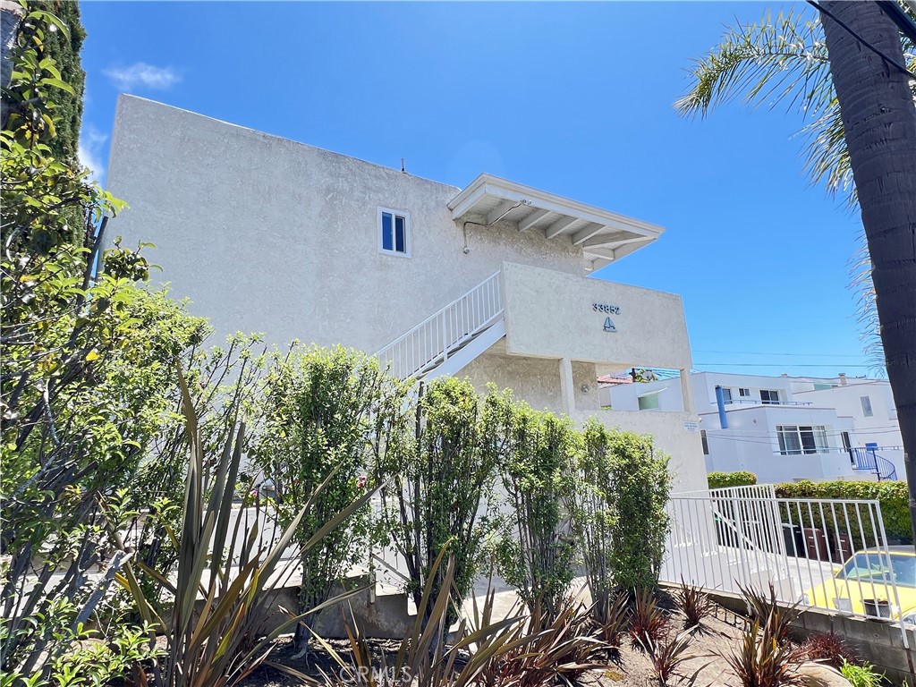 33852 Copper Lantern Street, Unit F Dana Point, CA 92629 - Photo 29 of 44 a front view of a house with a yard