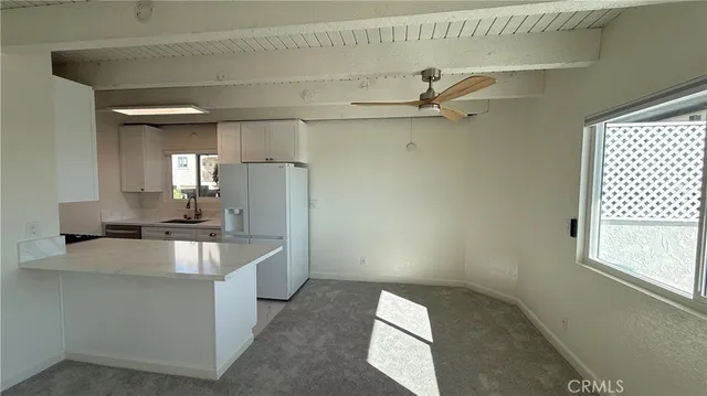 a kitchen with kitchen island a stove a faucet and a refrigerator